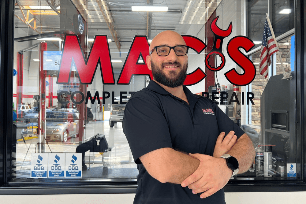 spring car maintenance, auto repair in Chandler, AZ at Mac's Complete Auto Repair. Makram Akram standing confidently in front of Mac’s Complete Auto Repair.