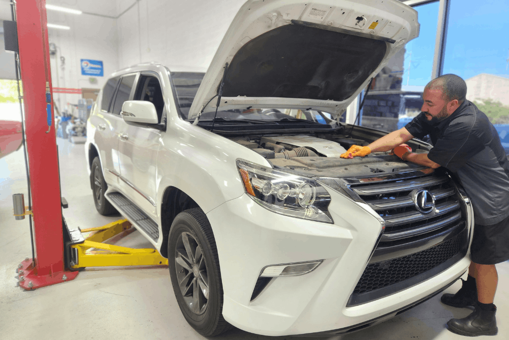 Japanese auto repair specialists in Chandler, AZ by Mac’s Complete Auto Repair. Mac Akram’s image inspecting the engine of a Lexus SUV inside a professional service bay, highlighting precise diagnostics, routine maintenance, and dependable luxury vehicle care.